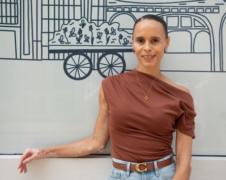 Natalie stands in front of a wall mural