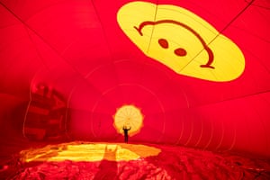 A pilot checks rigging inside a hot air balloon