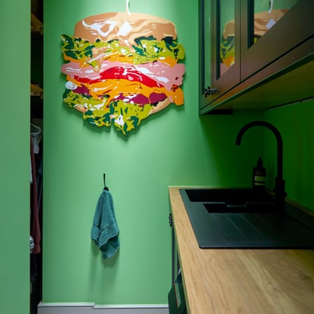 Green-painted utility room with sink