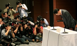 Toyota president Akio Toyoda bows at the start of a news conference in Nagoya