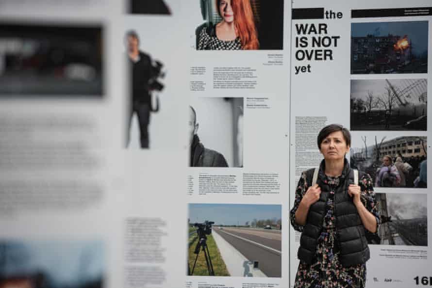A woman reads from The War Is Not Over exhibition stands in Taras Shevchenko Park in Kyiv. The exhibition showcases the work of journalists who have been killed, injured, come under fire, captured or persecuted since the beginning of Russia’s latest invasion of Ukraine.