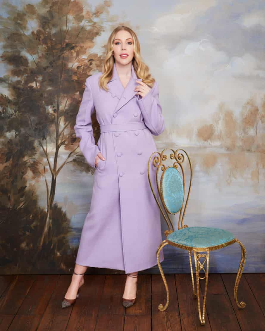 Katherine Ryan, lasting adjacent to an antique chair, successful an ankle-length lilac wintertime coat