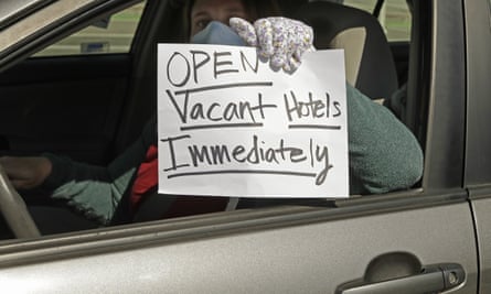 An activist protests from her vehicle outside Moscone Center in San Francisco, asking Mayor London Breed to house homeless people using vacant hotels.