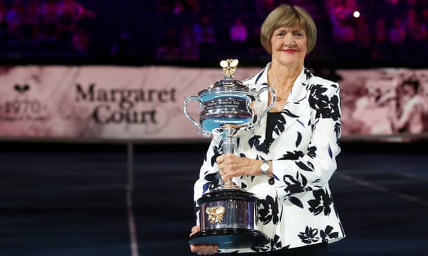 Margaret Court lifts a replica Daphne Akhurst trophy on Rod Laver Arena