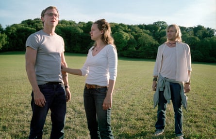 Daniel Craig, Samantha Morton and Rhys Ifans standing in a field