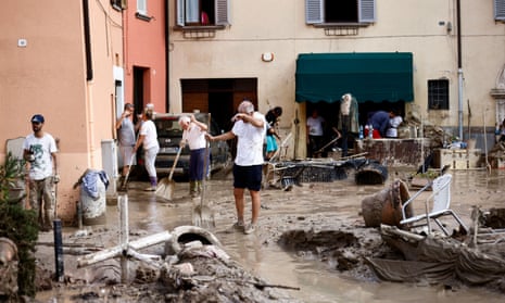 People work to clear way after heavy rains and deadly floods hit the central Italian region of Marche, in Cantiano, Italy.