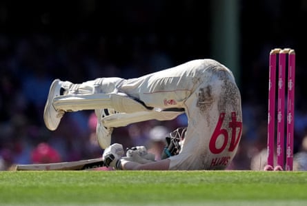 Steve Smith on the ground with his legs in the air