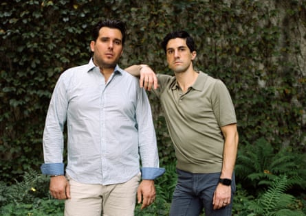 Nicholas Maggipinto and Corey Briskin standing together outside against an ivy-covered wall