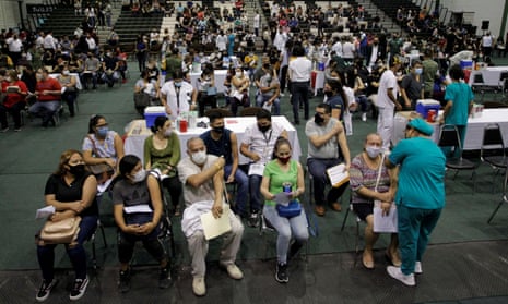 Teachers and school staff sit before receiving a dose of China’s CanSino Covid vaccine during a mass vaccination against coronavirus disease at the Autonomous University of Nuevo Leon in San Nicolas de los Garza, on the outskirts of Monterrey, Mexico 27 April 2021.