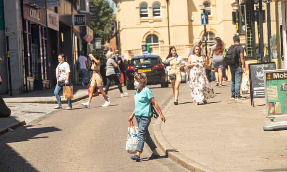 People walking on streets in Bishop’s Stortford, some wearing masks outside