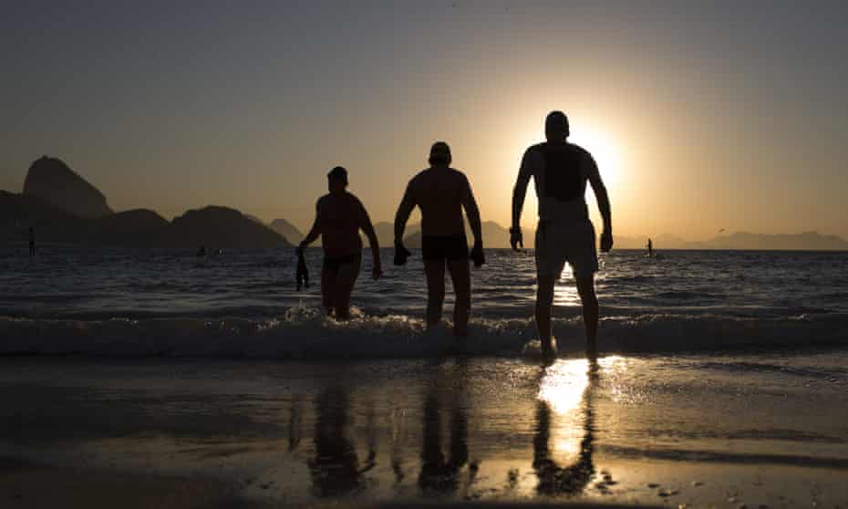 People enter the water for a morning swim on Copacabana beach. AP tests have indicated tourists could face serious health risks at the famous destination