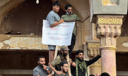 Protesters outside a mosque in Derna