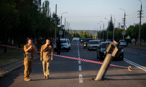 Ukrainian military members near a missile that landed in a road in Kramatorsk, eastern Ukraine, after Russian shelling on Saturday.