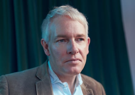 Closeup portrait of Danny Kruger in a white shird and tan jacket