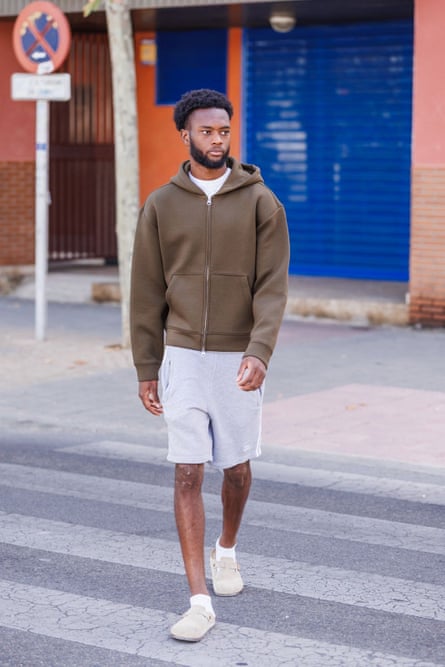 Abu Kamara crosses the street during a photoshoot for the Guardian