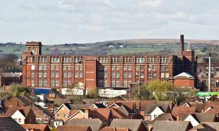 An old cotton mill in Bury, with moorland behind. 