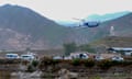 The helicopter is seen taking off at the Iranian border with Azerbaijan: it is a small twin-blade aircraft with white and blue livery and is pictured rising from a remote-looking airfield against a backdrop of a rocky ledge and mountains.