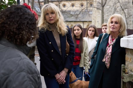 Two blond women stand at a doorway, flanked by three teenagers.