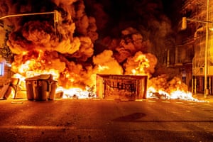 A burning skip forms a barricade across a street in Barcelona