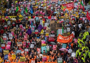 Protesters march holding placards during the Britain Is Broken rally, organised by the Peoples Assembly Against Austerity, in London