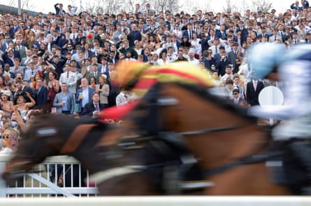 A packed crowd watch the third race in the Liverpool sunshine on 10 April 2026.