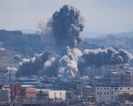 Giant clouds of smoke and debris rise up above buildings in Tyre hit with a missile