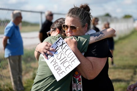 Protesters hold up signs