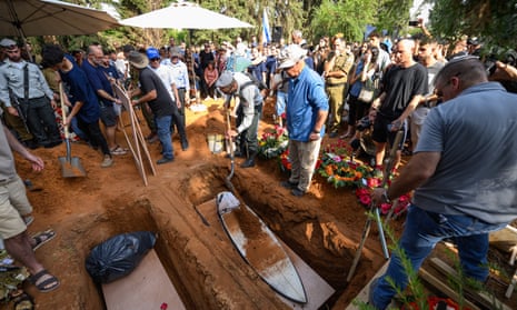 Friends and family pay their respects. The family chose to bury Carmel with his favourite surf board.