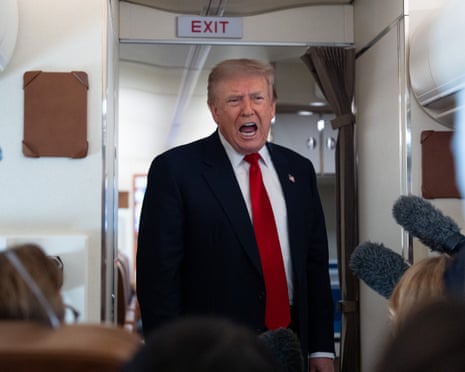 Donald Trump speaks with reporters on Air Force One en route to Michigan.