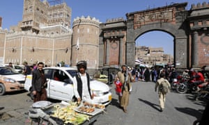 Yemenis walk through a market in the old city of Sanaa on 11 February 2017. 