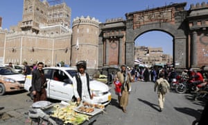 Yemenis walk through a market in the old city of Sanaa on 11 February 2017.