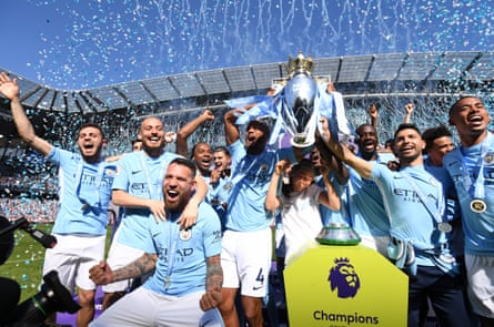 Vincent Kompany and Manchester City players celebrate lifting the Premier League trophy amid confetti