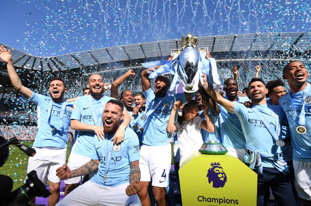 Vincent Kompany and Manchester City players celebrate lifting the Premier League trophy amid confetti