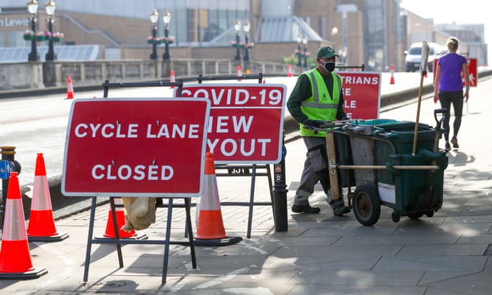 Temporary signage at a pinch point on Kingston Bridge in London turning the cycle lane a pedestrian route to help with social distancing.