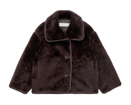 A short brown faux fur coat on a white background