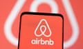 Screen with Airbnb logo in front of an Airbnb logo background