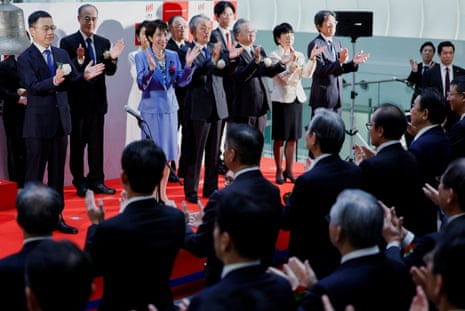 Japan's PM Sanae Takaichi and attendees applaud during the ceremony marking the end of trading in 2025 at the Tokyo Stock Exchange