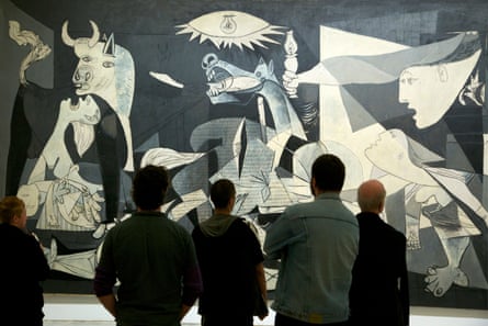 Masterpiece … visitors admire Guernica at the Reina Sofía Museum of Modern Art in Madrid.