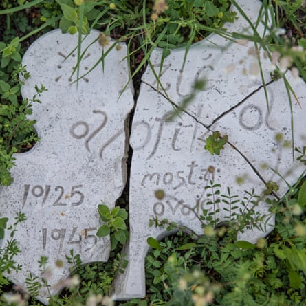 Smashed memorial stones in the grass