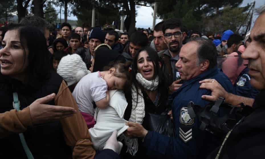 Refugees scuffle with Greek police near the village of Idomeni