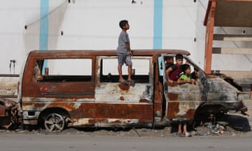 Children play in a charred van in Rafah.