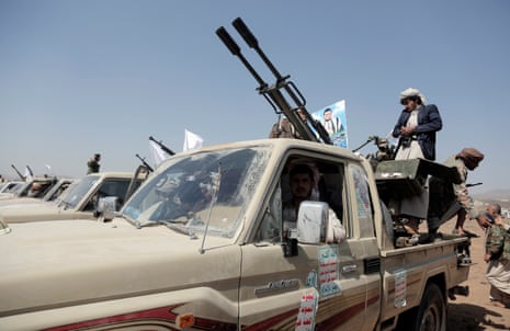 Houthi fighters man heavy machine guns mounted on vehicles at a rally in support of Palestinians in the Gaza Strip