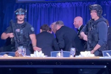 US President Donald Trump is escorted out as a shooter opens fire during the annual White House Correspondents’ Association dinner.