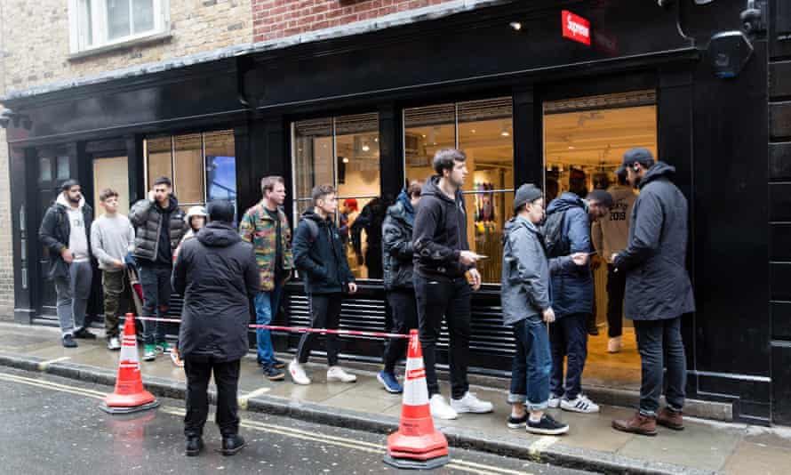 Customers hand over their tickets to gain access to the Supreme Soho store.
