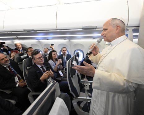 Pope Leo XIV greets journalists aboard the papal plane bound for Paris, as he begins his four-day visit to France.