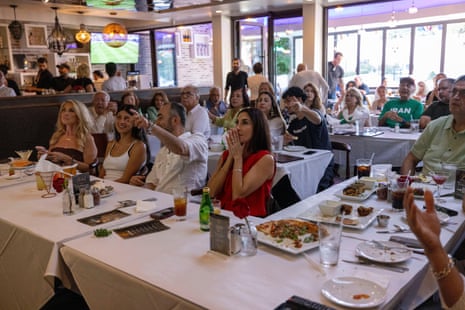 Fans watch a televised World Cup Group G soccer match between Iran and New Zealand in Los Angeles.