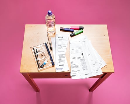 A view of a desk with torn exam papers on it.