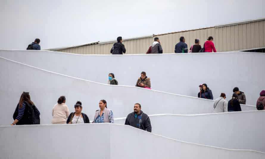 People wait outside a border office in Tijuana, Mexico.