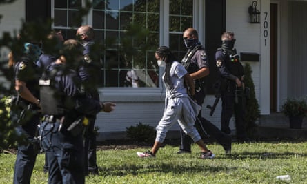 A protester is arrested on 15 July after sitting in the front yard of the home of the Kentucky attorney general, Daniel Cameron, in Louisville, Kentucky, chanting Breonna Taylor’s name as well as calling for justice.