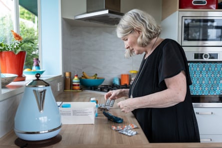 Jane Harrison at home preparing her husband’s medication